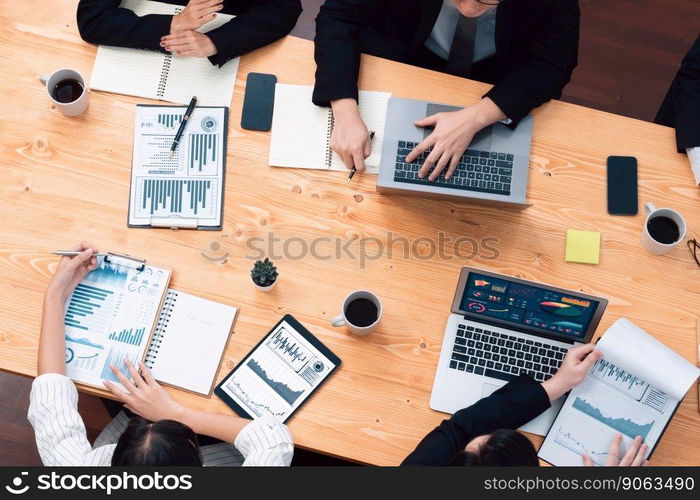 Top-view closeup business team of financial data analysis meeting with business intelligence, report paper and dashboard on laptop. Business group people working together in harmony office.. Business team of financial data analysis meeting report paper in harmony office.