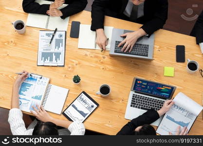 Top-view closeup business team of financial data analysis meeting with business intelligence, report paper and dashboard on laptop. Business group people working together in harmony office.. Business team of financial data analysis meeting report paper in harmony office.