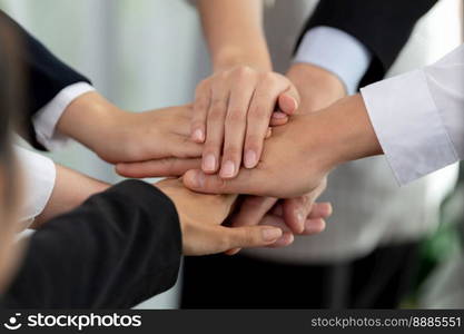 Top view closeup business team of suit-clad businesspeople join hand stack together. Colleague collaborate and work together to promote harmony and teamwork concept in office workplace.. Top view closeup business team join hand stack together for harmony concept.