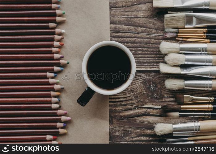 top view coffee cup brushes crayons