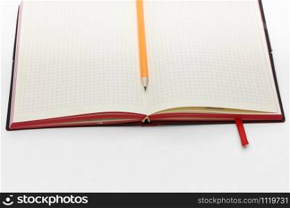 Top view collection of black hardcover notebook, white open flip curl rolled page and pencil isolated on background for mockup. Business concept. Top view collection of notebook, white open flip curl rolled page and pencil on background for mockup