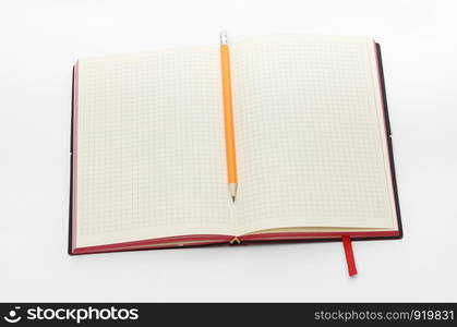 Top view collection of black hardcover notebook, white open flip curl rolled page and pencil isolated on background for mockup. Business concept. Top view collection of notebook, white open flip curl rolled page and pencil on background for mockup