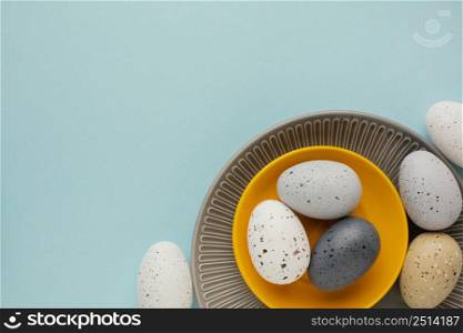 top view colored easter eggs multiple plates with copy space