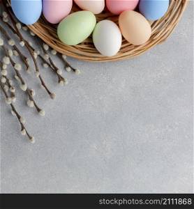 top view colorful easter eggs basket with flowers copy space