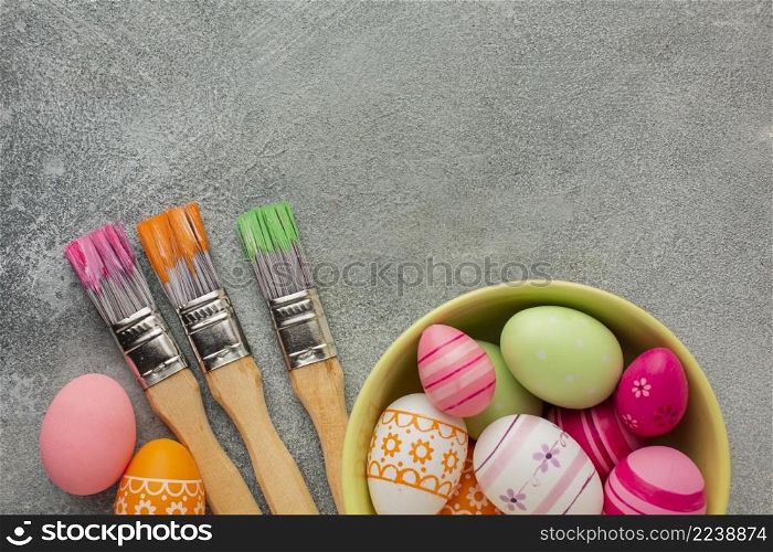 top view colorful easter eggs bowl with paint brushes copy space