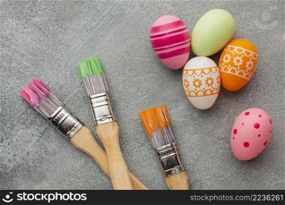 top view colorful easter eggs with paint brushes
