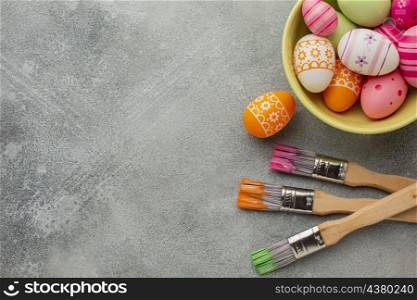 top view colorful easter eggs with paint brushes copy space