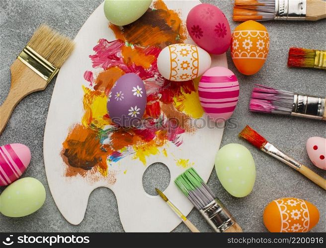 top view colorful easter eggs with paint brushes palette