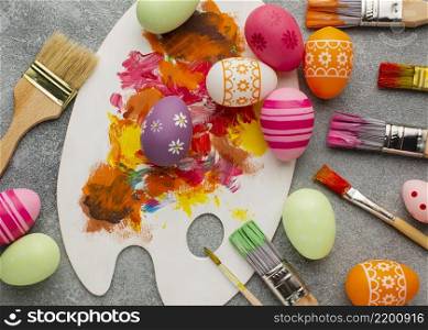 top view colorful easter eggs with paint brushes palette