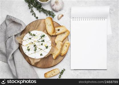 top view composition with delicious local food meal with empty notepad
