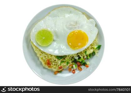 top view cooked instant noodles with fried egg , slices lime, chili and vegetable on dish over white background