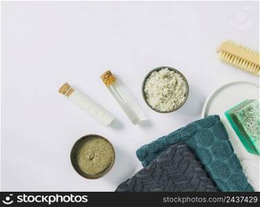 top view cosmetic herbal scrub brush napkin soap bar white surface