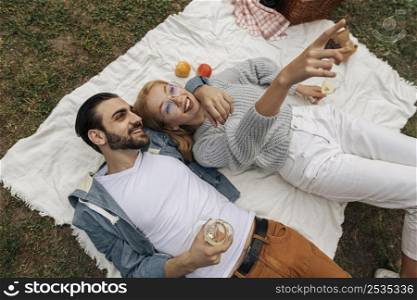 top view couple having picnic together outside