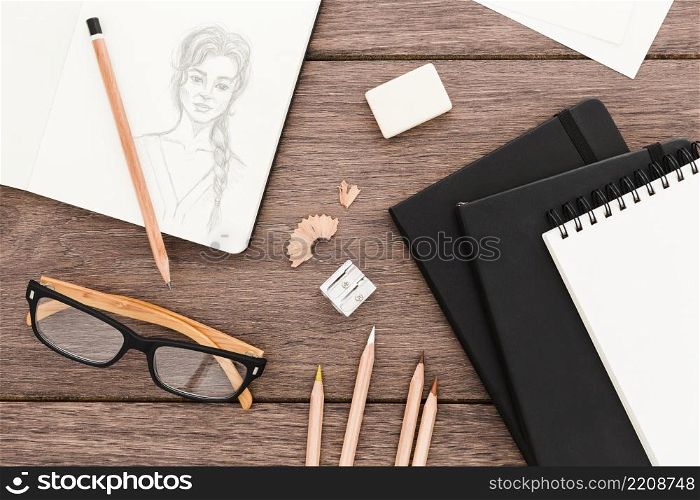 top view creative workplace with drawing