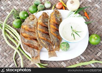 Top View Crispy fish with local platter with various vegetables as a side dish, ready to serve