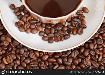 top view cup of coffee and roasted coffee beans close up