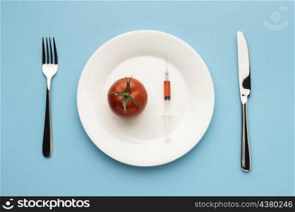top view cutlery tomato with syringe