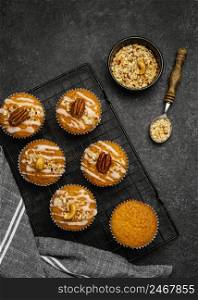 top view delicious muffins with nuts cooling rack