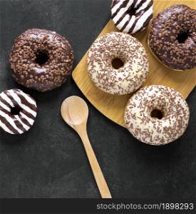 top view donuts chopping board with wooden spoon. Resolution and high quality beautiful photo. top view donuts chopping board with wooden spoon. High quality beautiful photo concept