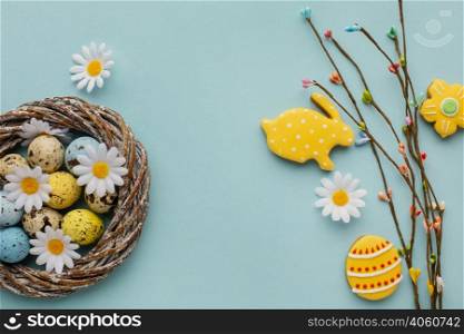 top view easter eggs basket with chamomile flowers