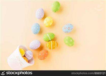 Top view easter eggs in basket filled fall down spread isolated on pastel background, Happy Easter Day, Creative composition banner web design holiday background, flat lay top view