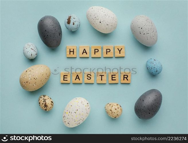top view easter eggs with greeting made wooden cubes