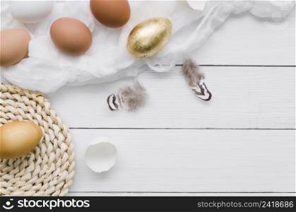 top view eggs easter with gold paint feathers