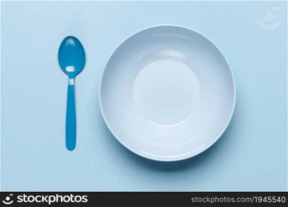 top view empty blue bowl spoon. High resolution photo. top view empty blue bowl spoon. High quality photo