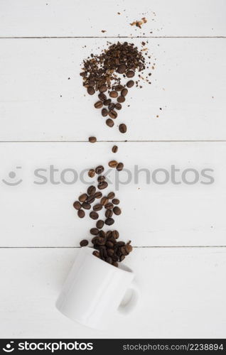 top view fallen cup with coffee grains
