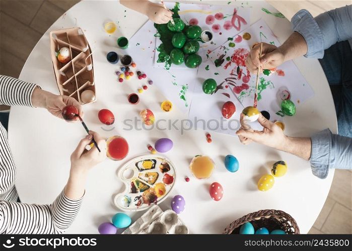 top view family painting eggs easter
