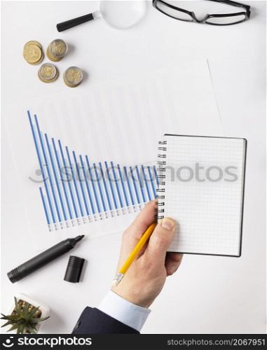 top view finances elements composition with empty notepad