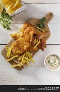 top view fish chips chopping board with sauce