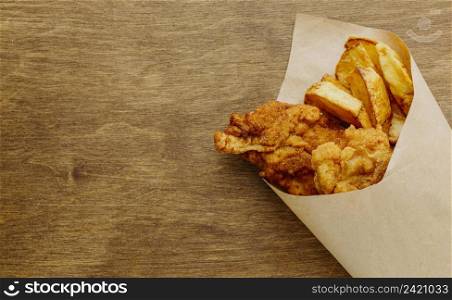 top view fish chips paper wrap with copy space