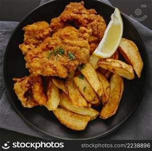 top view fish chips plate with lemon slice