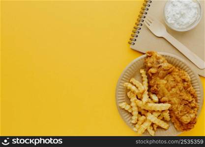 top view fish chips plate with notebook fork