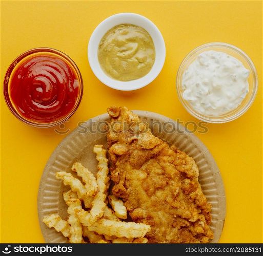 top view fish chips plate with sauces