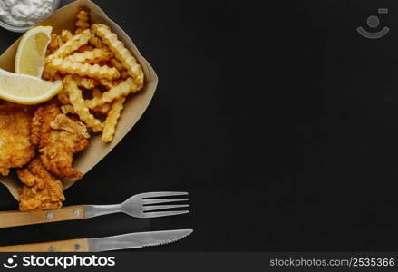 top view fish chips with sauce cutlery