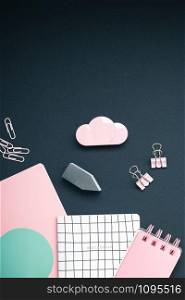 Top view flat lay feminine desk workspace styled pink colored objects design office supplies with copy space on black background. Template for blog social media