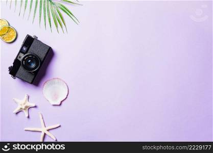Top view flat lay mockup of camera films, shells, leaves, starfish beach traveler accessories on a purple background with copy space, Business trip, and vacation summer travel concept