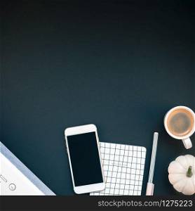 Top view flat lay of feminine desk workspace with white stereo bluetooth soundbar and smartphone for music listening and coffee cup with copy space on black background. Template for blog social media