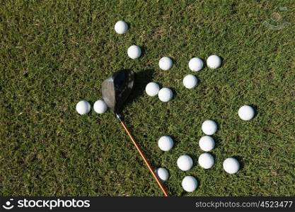top view flat lay of golf balls with driver on grass background