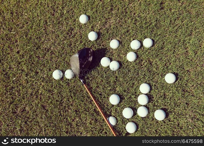 top view flat lay of golf balls with driver on grass background. golf balls background