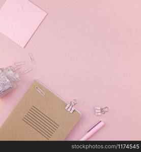 Top view flat lay of woman workspace desk styled design office supplies with copy space on a millennial pink color paper background minimal style. Square Template for feminine blog social media