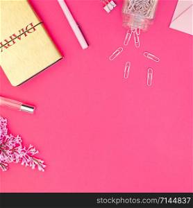 Top view flat lay of workspace desk styled design office supplies with copy space on a bright pink color paper background minimal style. Square Template for feminine blog social media