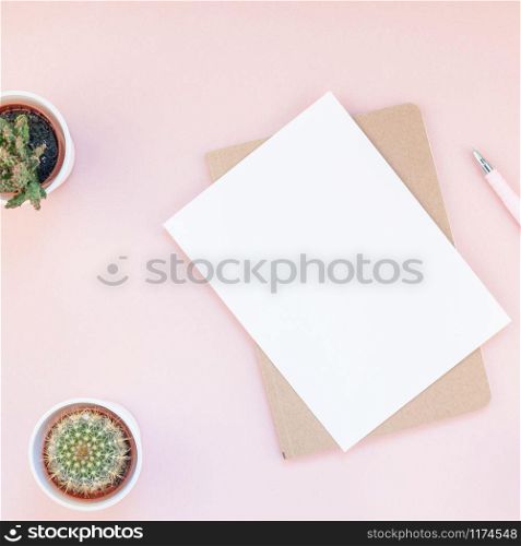 Top view flat lay workspace desk styled design office supplies cactuses succulents with copy space millennial pink color paper background minimal style. Square Template for feminine blog social media
