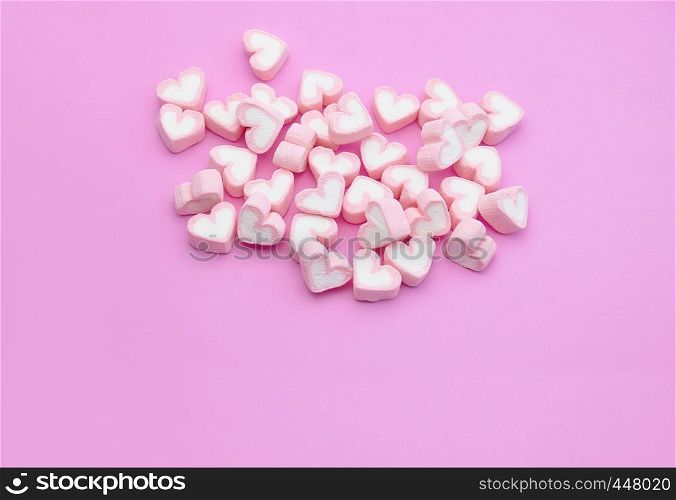 Top view, Flatlay template design a group of candy color of marshmallows with heart shaped on pink background with copy space, For web banner, brochure, menu template