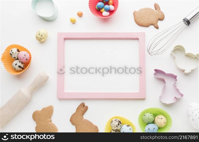 top view frame with easter bunny cookies kitchen utensils