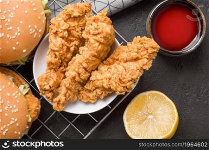 top view fried chicken burgers tray with sauce lemon. High resolution photo. top view fried chicken burgers tray with sauce lemon. High quality photo