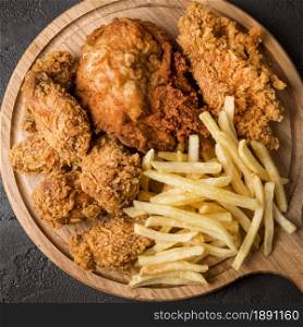 top view fried chicken with fries cutting board. Resolution and high quality beautiful photo. top view fried chicken with fries cutting board. High quality and resolution beautiful photo concept