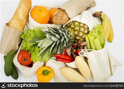 top view fruit vegetables reusable bags with bread